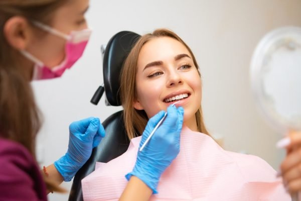 woman-patient-sitting-in-armchair-during-dental-treatment.jpg